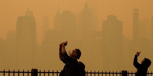 People take pictures of the haze