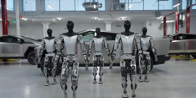 Photo of Tesla Robots in front of Cybertruck.