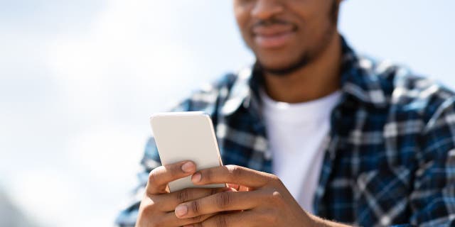 Cep telefonunu kullanan adam