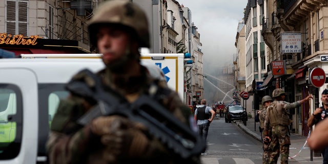 Armed French soldiers stands guard after Paris explosion