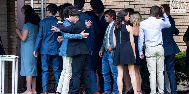Family and friends of Cameron Robbins arrive to the memorial service