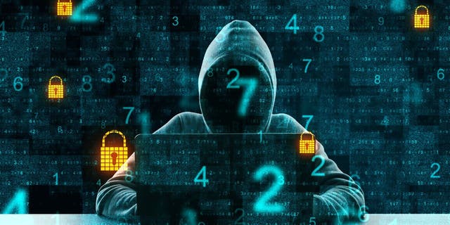 Hacker wearing a hoodie on laptop with numbers and locks popping up