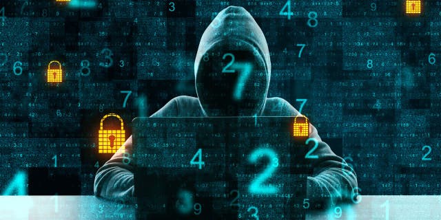 Hacker wearing a hoodie on laptop with numbers and locks popping up