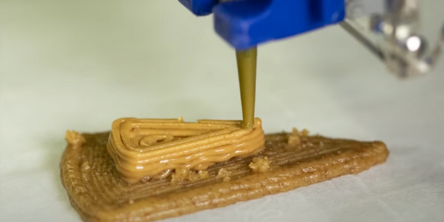 3-D printed graham cracker cheesecake being printed