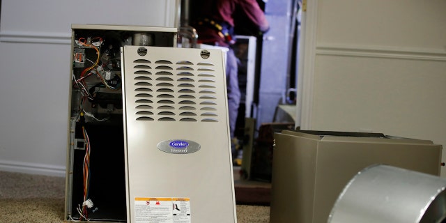 A new Carrier natural gas furnace at a residential home in Spanish Fork, Utah, U.S., on Tuesday, Oct. 19, 2021. Staying warm this winter in the country will come at a higher cost this year along with most other consumer expenses as heating oil, natural gas and other fuels surge in price, reports Newsweek. Photographer: George Frey/Bloomberg