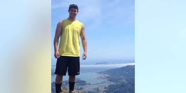 Matthew Nilo poses near a cliff overlooking San Francisco