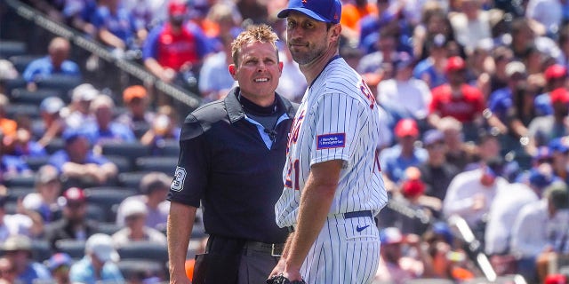 Max Scherzer speaks with the home plate umpire