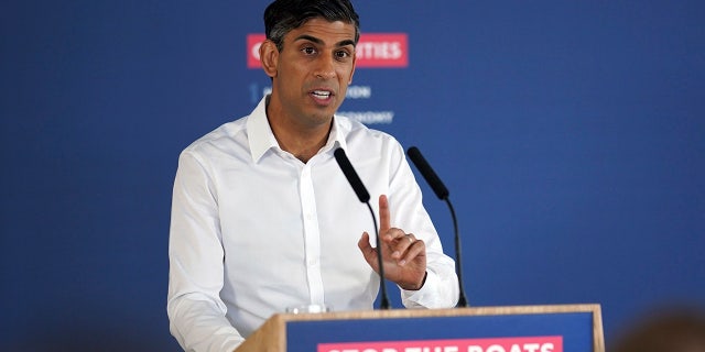 Rishi Sunak in front of stop the boats podium