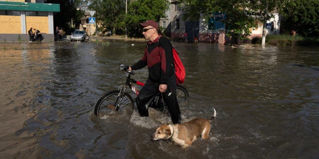 Man wades through Kakhovka dam flooding