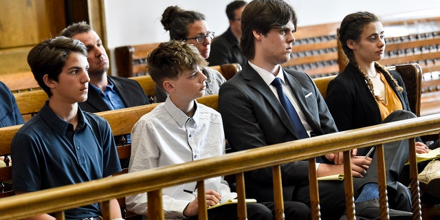 Several teens sitting in court