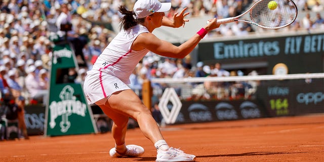 Iga Swiatek plays a shot at the French Open