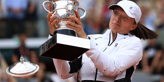Iga Swiatek celebrates winning the French Open