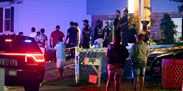 People standing around a house