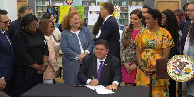 Illinois Gov. JB Pritzker signing a bill