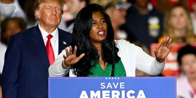 Kristina Karamo in front of Donald Trump