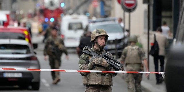 French soldier secures area by Paris explosion and fire