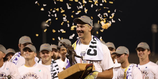 LSU pitcher Paul Skenes holds trophy