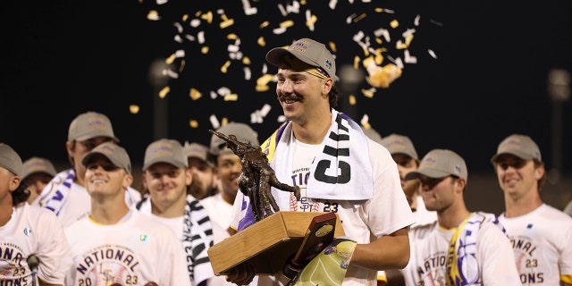 LSU pitcher Paul Skenes holds trophy