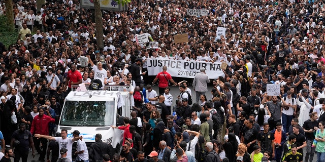 Protesters marching and holding signs