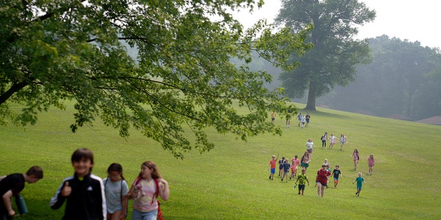 Kids walk across the YMCA Camp Kon-O-Kwee