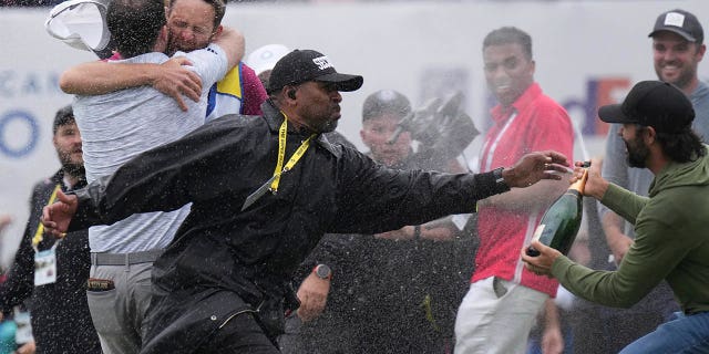 Adam Hadwin tries to celebrate