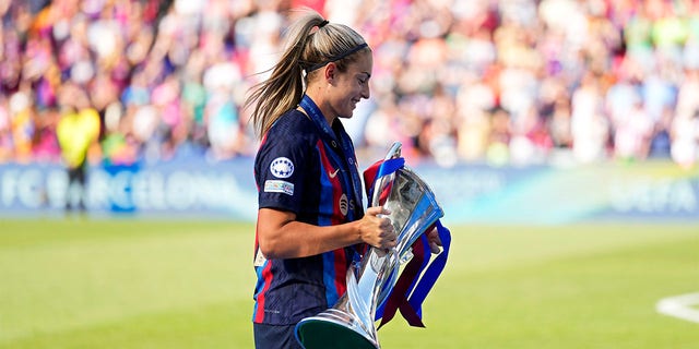 Alexia Putellas carries trophy