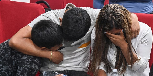 Kataleya Mia Chicillo Alvarez's family huddle with their arms wrapped around each other