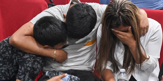 Kataleya Mia Chicillo Alvarez's family huddle with their arms wrapped around each other