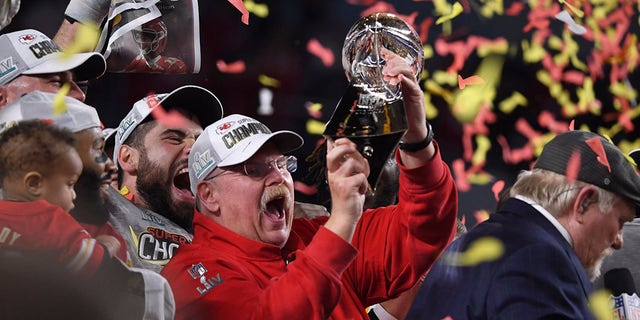 Andy Reid holds trophy