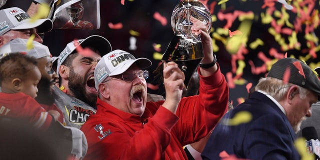 Andy Reid holds trophy
