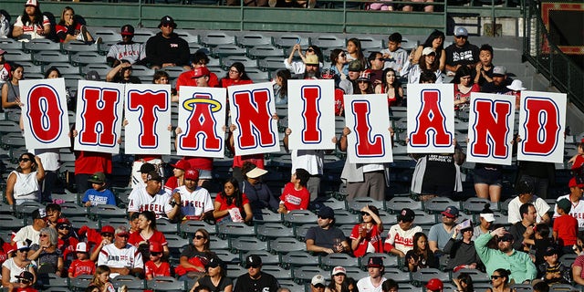 Angels fans hold a Shohei Ohtani sign