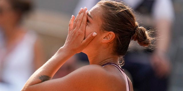 Alina Saravenka reacts after the shot