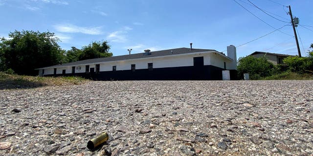 Shell casing outside the Outcast motorcycle gang clubhouse