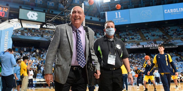 Dick Vitale walks on the basketball court before a game