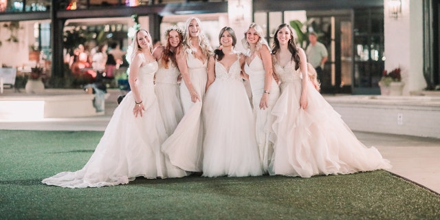 The 'Bonin Girls' pose for a photo while wearing white gowns.