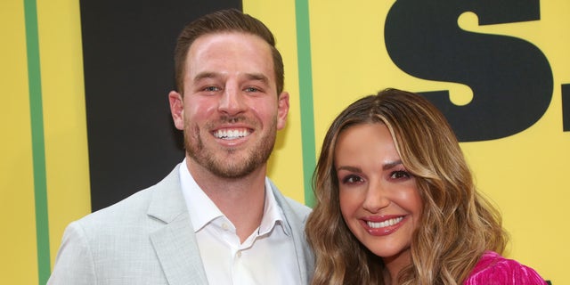 Carly Pearce smiling with Riley King at an event