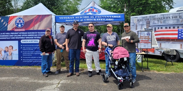 Michael R. Carmichael with fellow veterans at outdoor event