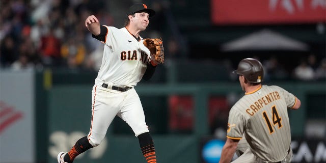 Casey Schmitt throws to first