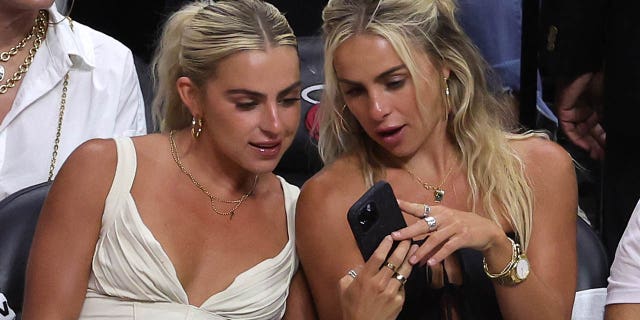 Cavinder twins look at their phone