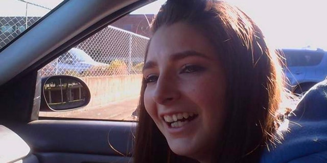 Charity Perry laughs in the passenger seat of a car