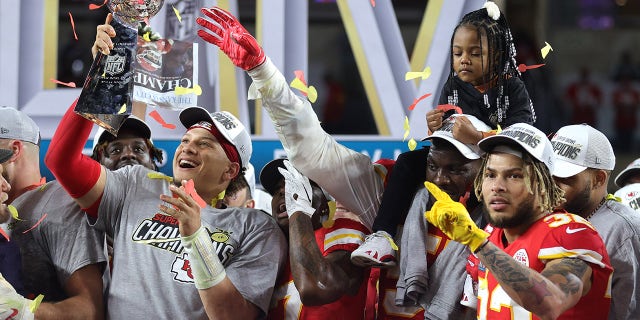 Patrick Mahomes holds trophy