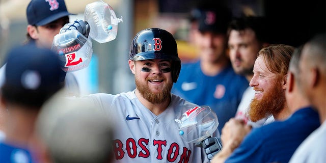 Christian Arroyo celebrates in dugout