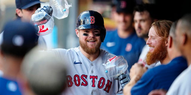 Christian Arroyo celebrates in dugout
