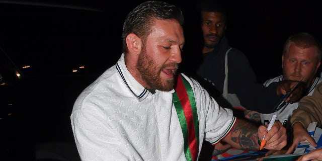 Conor McGregor signs autograph