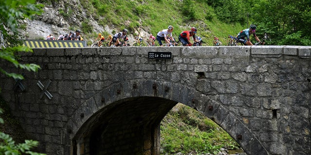 Cyclists travel over bridge