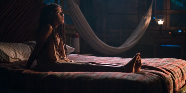 A scene from 'The Sound of Freedom' depicting a girl sitting on a bed
