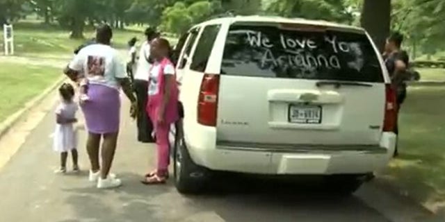 An SUV with we love you arianna written on back