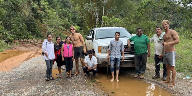 Daniel Penny shown shirtless with a group of locals on a roadtrip in South America.