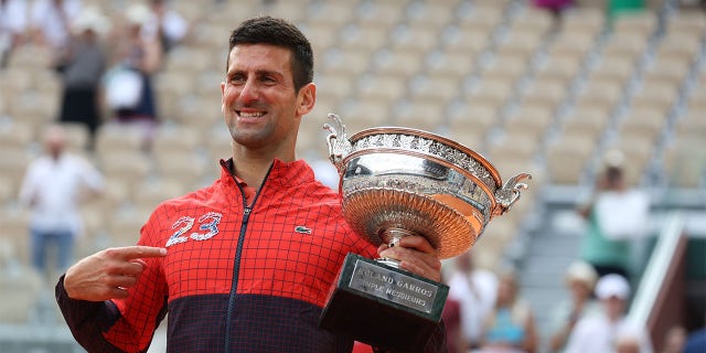 Novak Djokovic celebrates with trophy