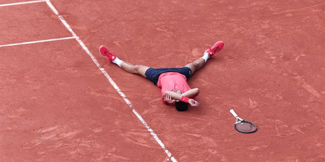 Novak Djokovic lays on ground
